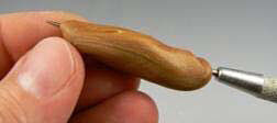 Molded clay being punctured with an awl